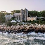 Photograph of Hammond Castle Museum on the rocky coast with waves