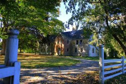 View of house at Spencer Peirce Little Farm from behind fence in Newbury, Massachusetts